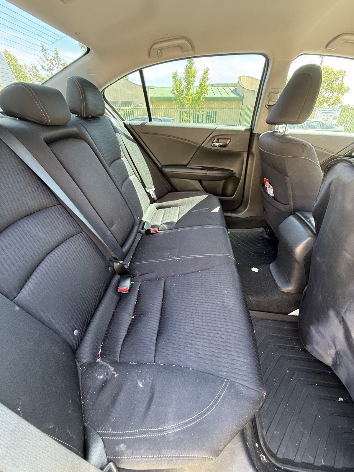 Honda Accord back seats before interior detail, with food crumbs and debris