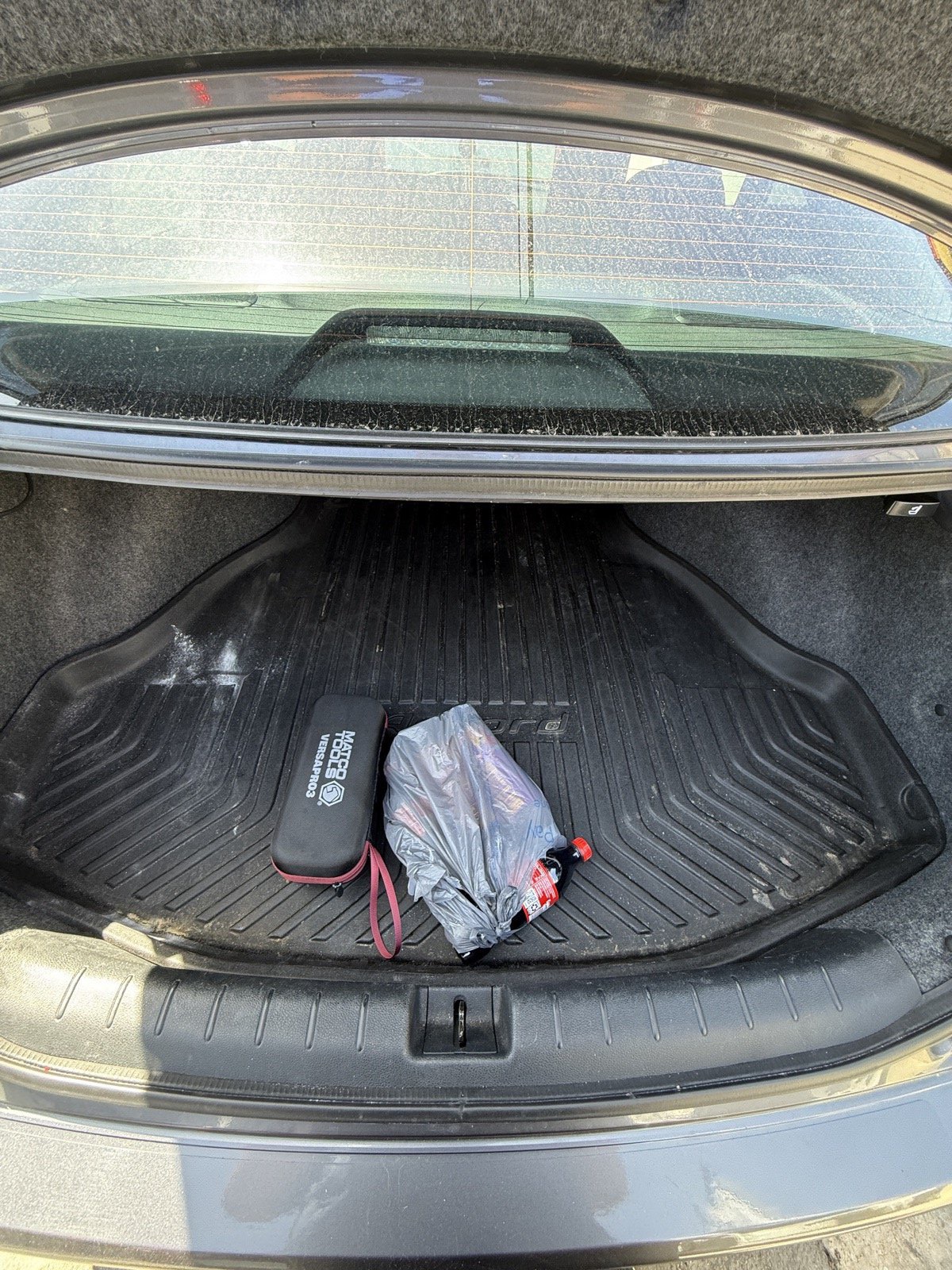 Honda Accord trunk before detail, with debris and dust on the liner