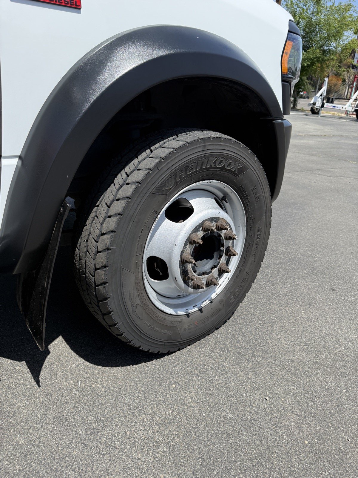Same truck wheel after deep clean — chrome shining and tire dressed